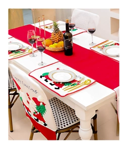 Close-up of festive Christmas table runner and placemats with Santa Claus embroidery