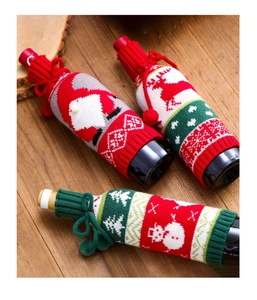 Close-up of knitted Christmas wine bottle covers with Santa, reindeer and snowman designs