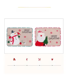 Detailed macro view of linen Christmas placemats with Santa and snowman embroidery