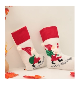 Detail of Christmas stockings with gnome embroidery and Merry Christmas text decor