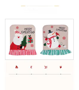 Detail of embroidered Santa and Snowman linen chair covers with festive ruffled lace trim
