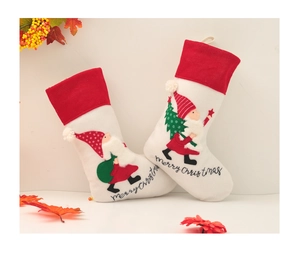 Close-up of embroidered Santa Claus and Merry Christmas text on festive stockings