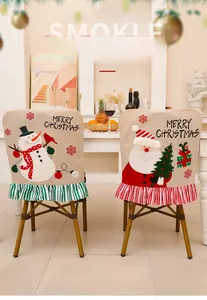 Detailed embroidery of Santa and Snowman on linen Christmas chair covers with striped frills