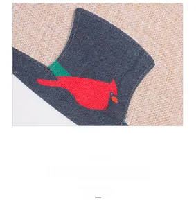 Detail of Christmas table runner featuring embroidered red cardinal and festive top hat decor