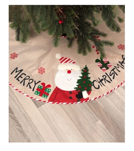 Detail of burlap Christmas tree skirt featuring Santa Claus embroidery and Merry Christmas text