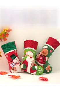 Detail view of knitted Christmas stockings featuring embroidered Santa, snowman, and gingerbread man