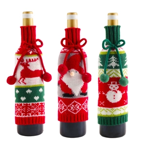 Three-piece knitted Christmas wine bottle covers with reindeer, Santa, and snowman designs