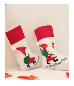 Detail of two Christmas stockings with gnome embroidery and Merry Christmas text