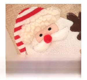 Detailed embroidery of Santa Claus on a burlap Christmas stocking with plush beard