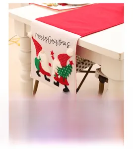 Detail of Christmas table runner with embroidered gnomes and Merry Christmas text