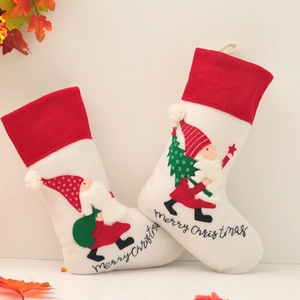 Set of two embroidered Christmas gnome stockings in cream and red with Merry Christmas text