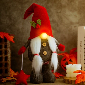 Lighted Christmas gnome plush with red felt hat and star charm on festive table