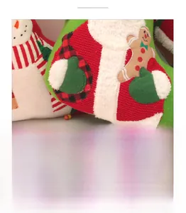Close-up detail of knitted Christmas stocking with plush embroidery and festive fabric texture