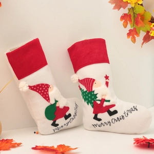 Set of two white and red Christmas stockings with Santa embroidery and festive decorations