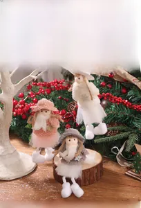 Detailed view of plush angel doll ornaments with lace dresses and straw hats