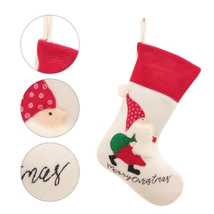 Red and cream Christmas stocking featuring gnome embroidery and Merry Christmas text