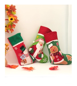 Close-up of three large embroidered Christmas stockings with Santa and Snowman designs