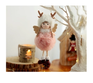 Detail of plush Christmas angel ornament with deer antlers on a decorative branch