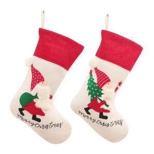 Pair of Christmas gnome stockings with red knit cuffs and merry christmas embroidery