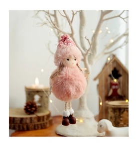 Detail of pink plush Christmas angel ornament with knitted hat hanging on a tree