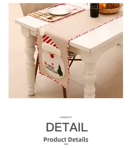 Detail of Christmas burlap table runner with embroidered Santa Claus and festive text