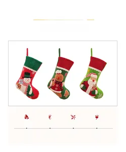 Detail of Christmas stockings with Santa, snowman and gingerbread man embroidery