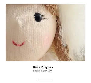 Close-up of plush angel doll face with stitched smile and soft fabric texture details