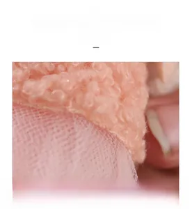 Detail of soft pink plush lamb wool fabric and delicate mesh gauze material layers
