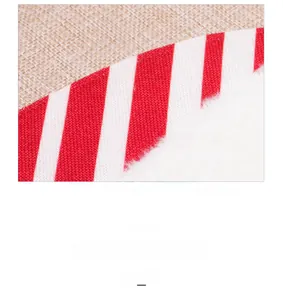 Detail of Christmas table runner with red white stripe fabric and white faux fur trim texture