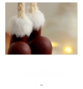Macro detail of Christmas angel ornament showing white faux fur and brown leather sphere