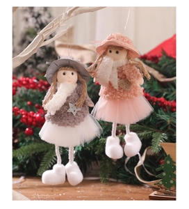 Close-up of pink and grey plush angel ornaments with mesh skirts on Christmas tree branches