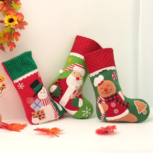 Three embroidered Christmas stockings featuring Santa, Snowman and Gingerbread Man characters