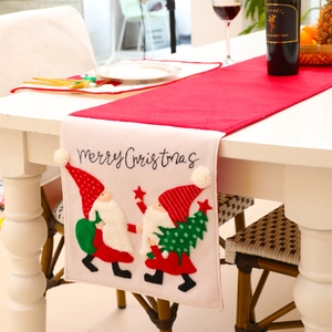 Christmas table runner with embroidered faceless gnomes and Merry Christmas text