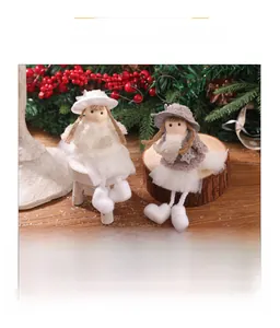 Close-up of plush Christmas angel dolls with lace hats and snowflake sequin details