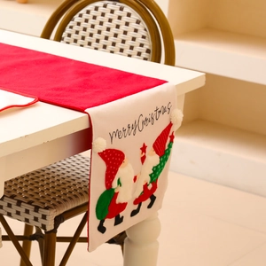 Red Christmas table runner with embroidered faceless Santa Claus and Merry Christmas text