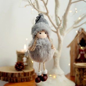 Plush Christmas angel doll pendant in grey knit hat hanging on a festive Xmas tree