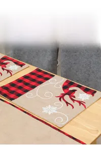 Detailed view of Christmas elk embroidery on a red and black buffalo plaid linen table runner