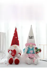 Close-up of couple gnome plush dolls with XOXO embroidery and heart decor for Valentines