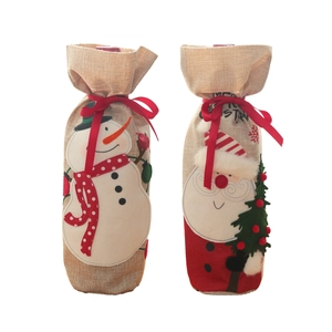 Christmas burlap wine bottle covers with embroidered snowman and Santa motifs and red ribbons