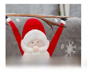 Detailed close-up of Santa Claus applique embroidery on grey linen Christmas table runner