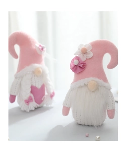 Detailed view of pink and white knitted Valentine's Gnomes with soft plush beards and hearts