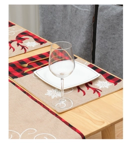 Detail of buffalo plaid Christmas table runner with reindeer and snowflake embroidery