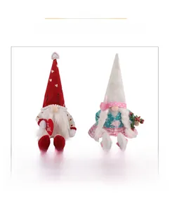 Close-up of Valentine couple gnomes holding hearts and bouquets in knit plush material