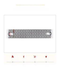 Detail of Christmas table runner featuring Santa Claus and white snowflake embroidery