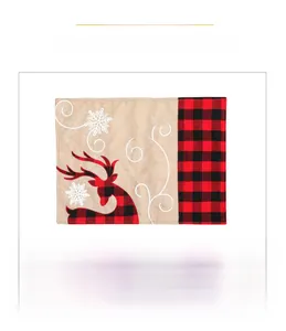 Detailed close-up of a rustic burlap Christmas placemat featuring red buffalo plaid reindeer
