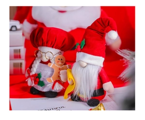 Detailed view of red and white Christmas gnomes with glasses holding a gingerbread man