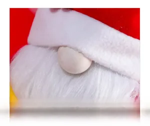 Macro view of Christmas gnome showing wooden nose, red velvet hat, and white plush beard