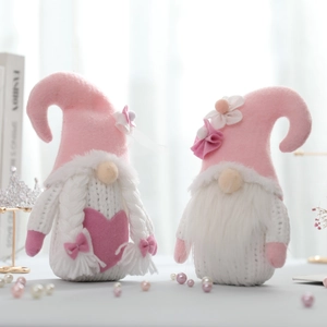 Pink and white knitted Valentine's Gnomes with heart and floral details for holiday decor