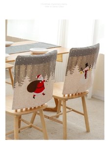 Detailed view of linen Christmas chair covers with Santa Claus and snowman motifs