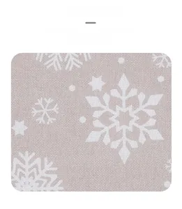 Close-up of linen table runner featuring printed white snowflake patterns on beige fabric